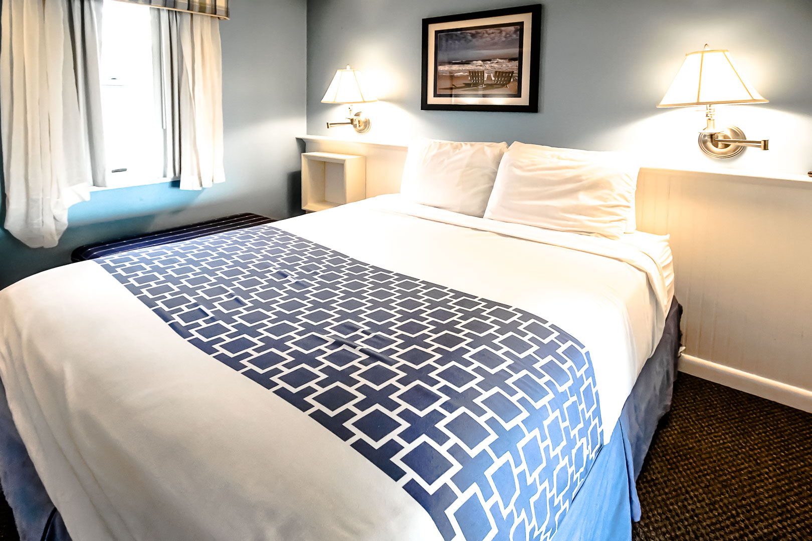 A crisp and clean master bedroom with a king size bed at VRI's Seawinds II Resort in Massachusetts.